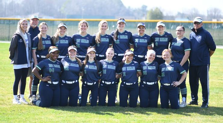 The 2022 Delaware Tech Softball team gathered in a group on a field for a photo